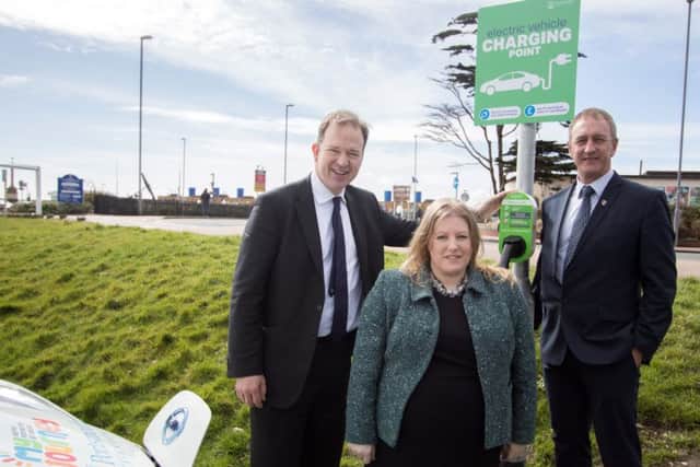 Transport Minister Jesse Norman with Cllr Donna Jones and Cllr Simon Bosher at one of the council's electric vehicle charging points