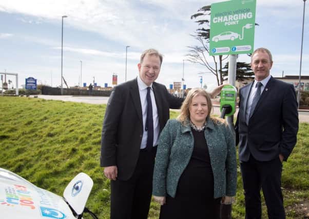 Transport Minister Jesse Norman with Cllr Donna Jones and Cllr Simon Bosher at one of the council's electric vehicle charging points