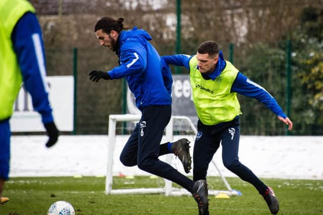 Staurt O'Keefe, right, battles Christian Burgess for the ball during Pompey training. Pictures: Colin Farmery
