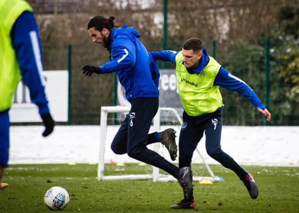 Staurt O'Keefe, right, battles Christian Burgess for the ball during Pompey training. Pictures: Colin Farmery