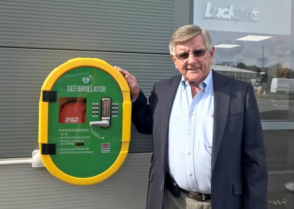 David Luckett with the firm's new defibrillator