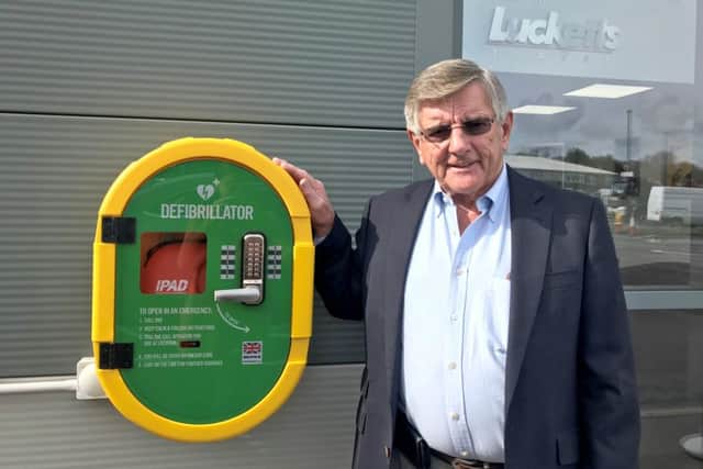 David Luckett with the firm's new defibrillator