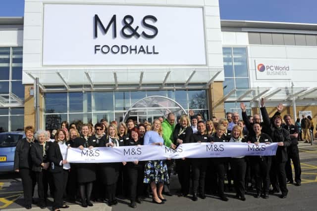 Store manager Sophie Thomas and 'The News Local Hero' Ben Brown, 34, from Cowplain along with the 60 strong team at the new store
Picture: Malcolm Wells (180321-1299)