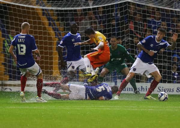 Pompey defend before their clash with Wycombe in 2013 is abandoned. Picture: Joe Pepler