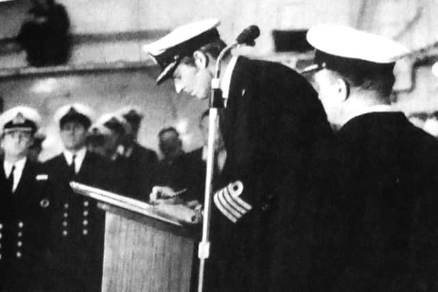 Captain Michael Livesay signing the ship on for service during the ceremony at Portsmouth naval base