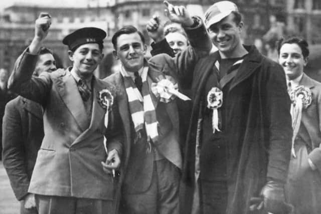 Up for the cup  Bernie Grant, left, raises a cheer wearing the sailor's cap. Len Durrant far right. Picture: Len Durrant Collection