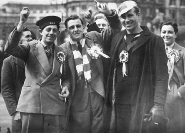 Up for the cup  Bernie Grant, left, raises a cheer wearing the sailor's cap. Len Durrant far right. Picture: Len Durrant Collection
