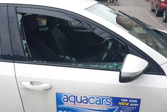 Ali Rahman is upset after his taxi was vandalised