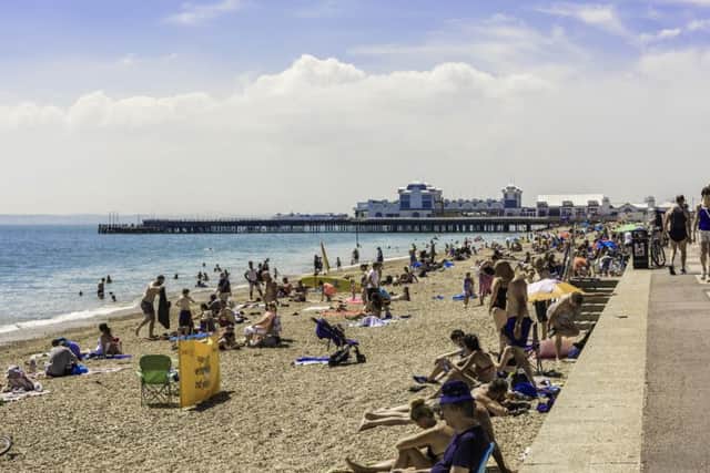 Beachgoers enjoy a sunny day in Southsea. Credit: Tony Western