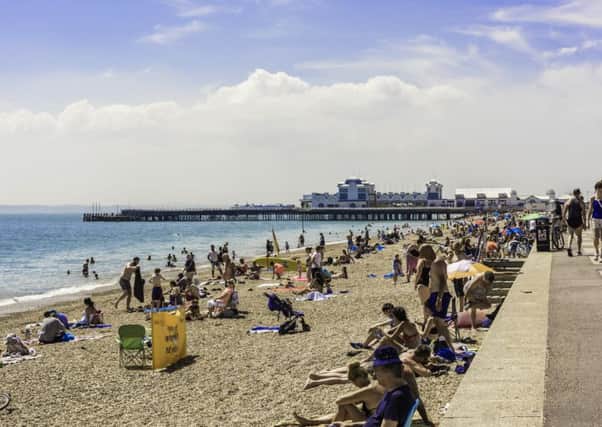 Beachgoers enjoy a sunny day in Southsea. Credit: Tony Western
