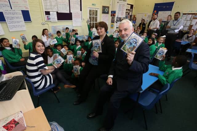 Teacher Catherine Smith, headteacher Polly Honeychurch and police and crime commissioner Michael Lane with Year 10 pupils and the Heartstone Odyssey book at Cottage Grove Primary School, Portsmouth     Picture: Habibur Rahman