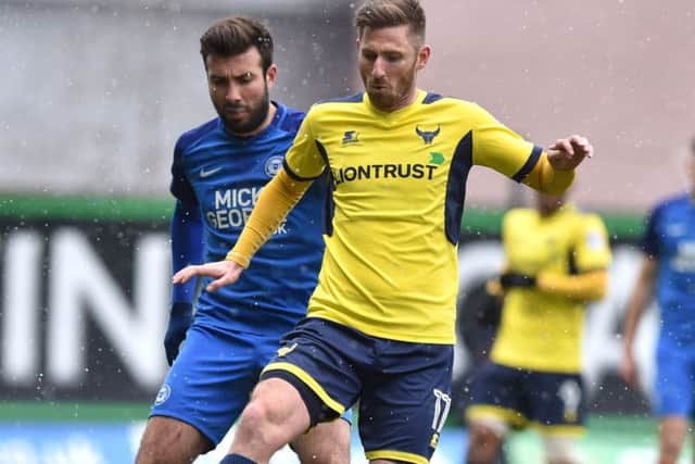 Oxford United's James Henry (right) and Peterborough United's Michael Doughty