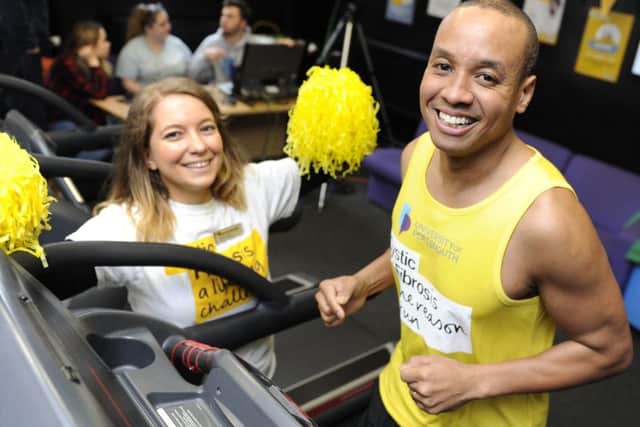 Former Great British Bake-off contestant Enwezor Nzegwu takes part in a 24-hour treadmill relay at Portsmouth University to raise money for cystic fibrosis. Fellow participant Dannii Hutchins gives support. Picture by Ian Hargreaves  (180224-1) PPP-180315-161657006