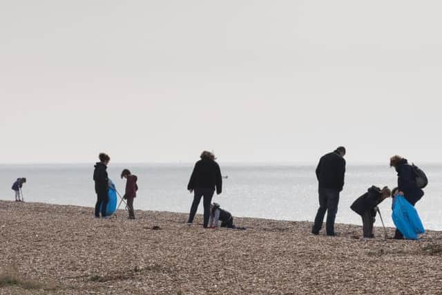 Volunteers at work clearing the beach of rubbish.Picture Credit: Keith Woodland (180261-013)