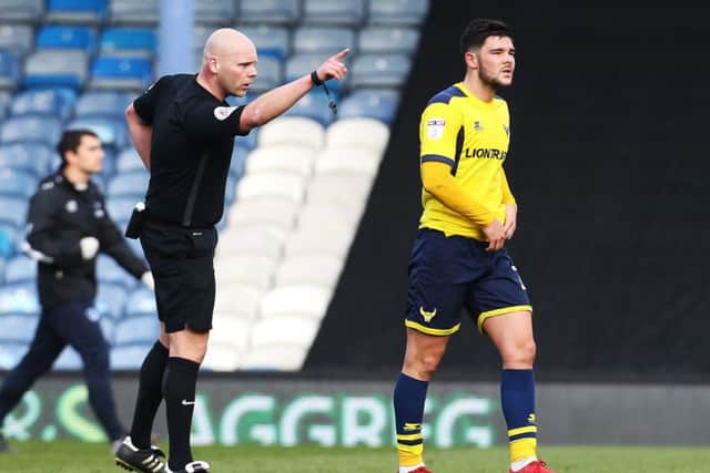 Referee Craig Breakspear sends off Oxford midfielder Alex Mowatt