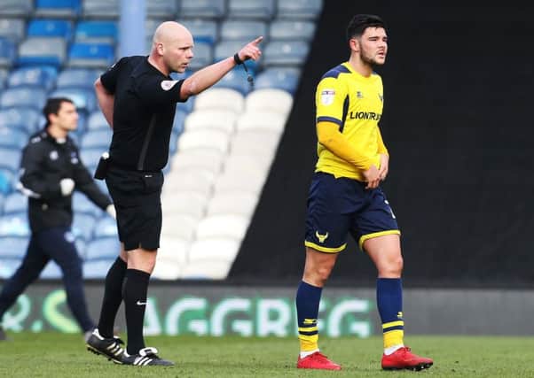 Referee Craig Breakspear sends off Oxford midfielder Alex Mowatt