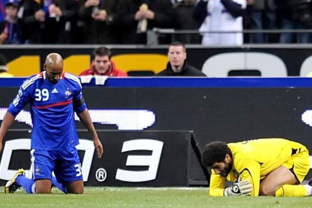 England goalkeeper David James and France's Nicolas Anelka lie on the ground after David James gave awayt a penalty