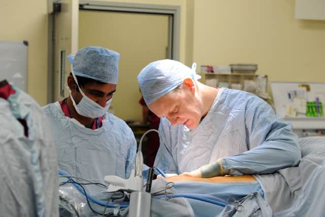 A surgeon at work in the operating theatre at QA Hospital