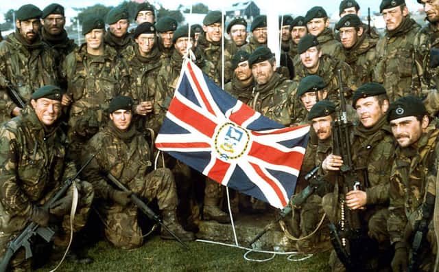 Fight of South Georgia - Royal Marines Naval Party 8901, the Royal Marine garrison of the Falkland Islands evicted by the Argentine invaders, with the Falkland Islands flag outside Government House, Port Stanley, after the Argentine surrender.