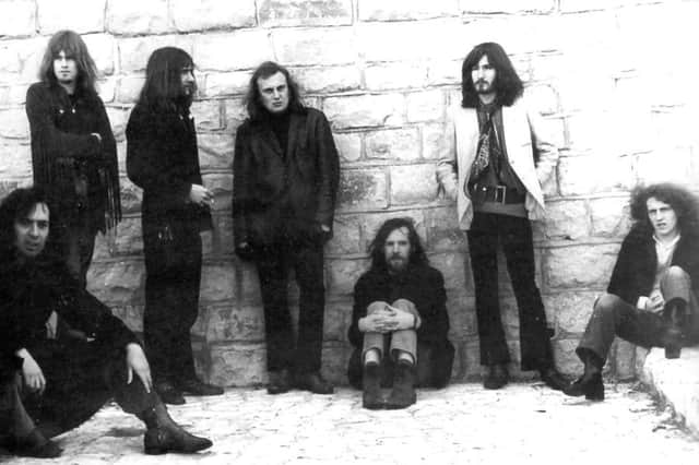 Mick Cooper with long hair and his band Heaven. Mick is sitting in the bottom left corner.