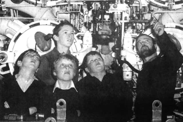 Chief petty officer W Murphy, right, introduces, from left, David Shepherd, Scott Macdonald, Shaun Thomas and Darron Hancock to the forward torpedo room of HMS Finwhale