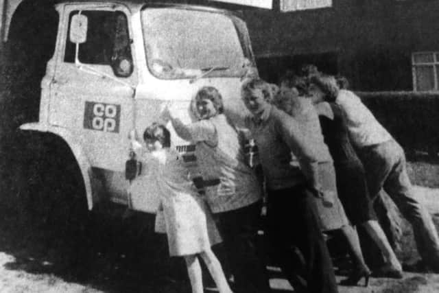 Residents of Willersley Close, Paulsgrove, try to free a Co-Op delivery van stuck in the mud