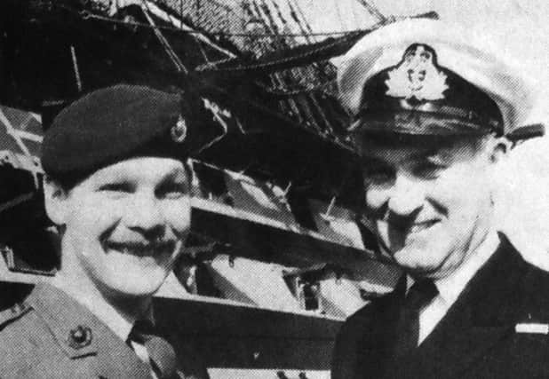 Marine Derek Tomsett, left, pictured with the captain of HMS Victory Lt Cmdr Charles Addis