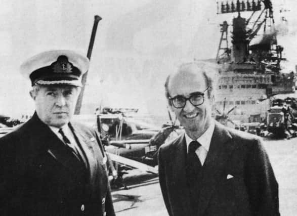Defence secretary John Nott with the captain of HMS Hermes, Capt Lyn Middleton pictured at the top of the Harrier jet ski-ramp at the bow of the aircraft carrier during the ministers visit to Portsmouth Naval Base