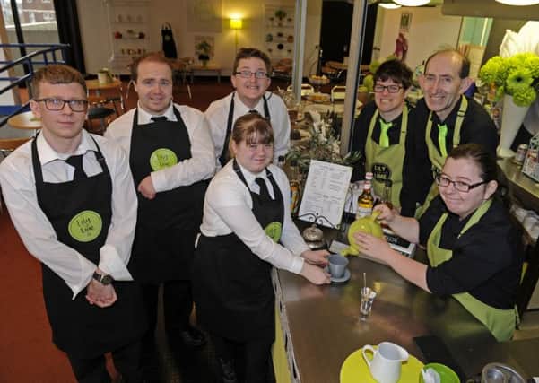 Adults with learning difficulties have been given the chance to work at the Lily and Lime cafe in the Central Library, Portsmouth (from left) Matthew Rimmer, Michael Lingley, Daniel Donovan, Lena Eldridge, Sarah White, Kevin Skilton and Louisa Edwards.
 Picture by Ian Hargreaves