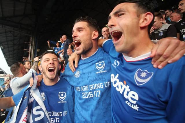 Gary Roberts, right, celebrates Pompey's League Two title triumph on the final day of last season. Picture: Joe Pepler