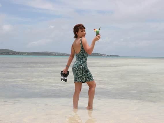 Katy Lette enjoys a cocktail on the beach