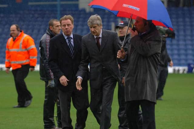 Harry Redknapp and Arsene Wenger inspect the pitch at Fratton Park