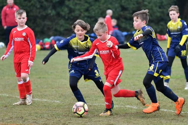Under-11s action from Horndean Youth, red, against Gosport Borough at Five Heads Park. Picture: Neil Marshall (171745-149)