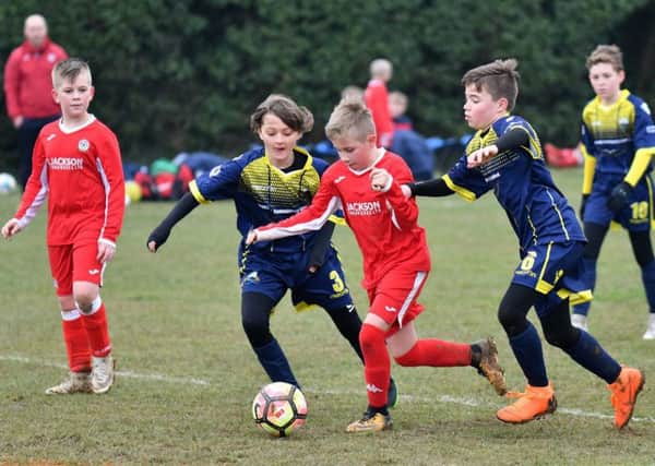 Under-11s action from Horndean Youth, red, against Gosport Borough at Five Heads Park. Picture: Neil Marshall (171745-149)