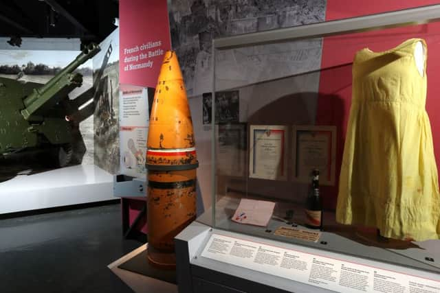 A British 25 pounder gun gun, a naval 15 inch shell of the type that would have been fired from a battleship, and a shift dress made from parachute silk in the refurbished D-Day Story museum Picture: Chris Moorhouse