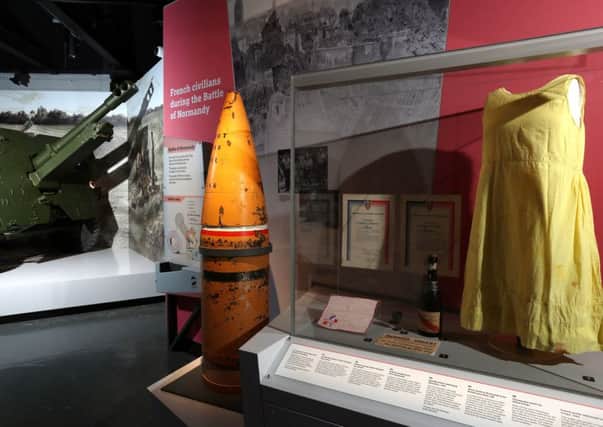 A British 25 pounder gun gun, a naval 15 inch shell of the type that would have been fired from a battleship, and a shift dress made from parachute silk in the refurbished D-Day Story museum Picture: Chris Moorhouse