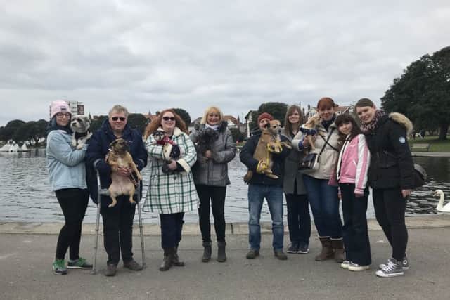 Grace Piper and Dixie, third-left, get ready to set off on a stroll from Canoe Lake in Southsea with fellow small dog owners from Portsmouth. Picture: Byron Melton
