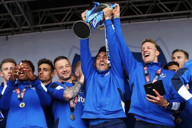 Gary Roberts lifts the League Two trophy during the celebrations on Southsea Common. Picture: Joe Pepler