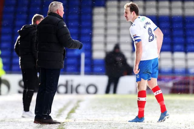 Brett Pitman talks with boss Kenny Jackett at Oldham. Picture: Joe Pepler