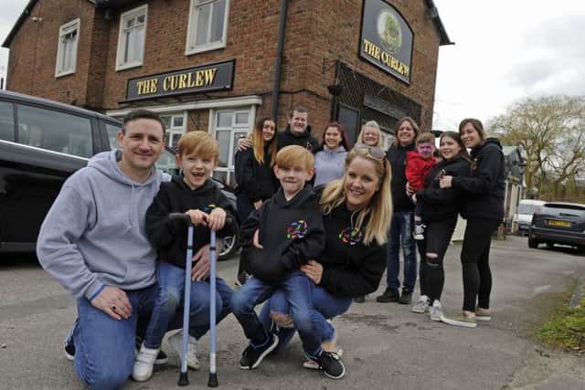 The Walking Fund charity has hosted the last ever fundraising event for Oakley Smith at The Curlew public house in Havant. From left at the front, dad Terry Smith, Oakley and his brother Mykey, eight, and mum Angie Mahon
Picture Ian Hargreaves (180445-1)