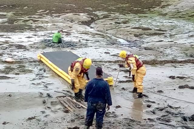 A boy, 11, is rescued after becoming stuck up to his waist in mud off the coast of Hayling Island on Easter Sunday. Picture: Erik Newport