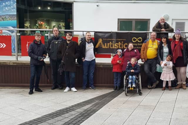 People from different organisations gathered to see the Spinnaker Tower light up gold for Autism Awareness Month. Picture: Julian Morgan