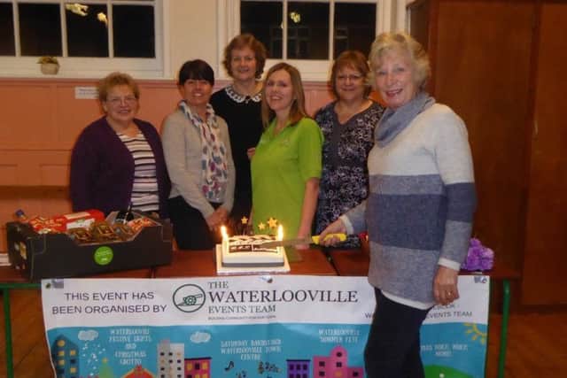 Waterlooville events team chairman Jackie Buckley cutting the first birthday cake. Looking on are pop up cinema volunteers from left to right Cath Percival, Lorna Ricketts, Denise Chart and Petra Harris. Also present is Jacqui Benham, the Community Champion at Asda Waterlooville