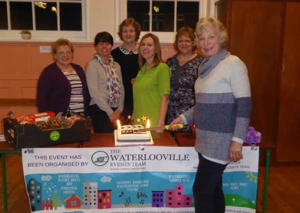 Waterlooville events team chairman Jackie Buckley cutting the first birthday cake. Looking on are pop up cinema volunteers from left to right Cath Percival, Lorna Ricketts, Denise Chart and Petra Harris. Also present is Jacqui Benham, the Community Champion at Asda Waterlooville