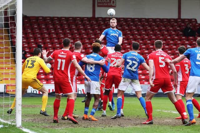 Jack Whatmough soars to win a header at Walsall. Picture: Joe Pepler