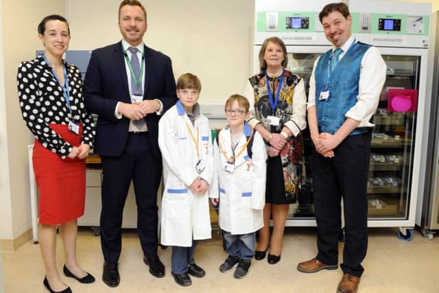 From left - Laura Wainwright (Consultant Clinical Biochemist), Mark Cubbon (Chief Executive of the Portsmouth Hospitals NHS Trust), Liam Merrick and brother Sam Merrick, Melloney Poole (Chairman of The Portsmouth Hospitals NHS Trust), and Andrew Flatt (linical Director of Pathology). Picture by Malcolm Wells (180405-3322.