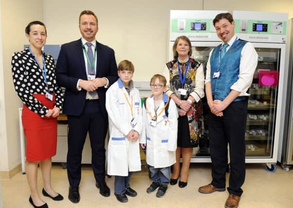 From left - Laura Wainwright (Consultant Clinical Biochemist), Mark Cubbon (Chief Executive of the Portsmouth Hospitals NHS Trust), Liam Merrick and brother Sam Merrick, Melloney Poole (Chairman of The Portsmouth Hospitals NHS Trust), and Andrew Flatt (linical Director of Pathology). Picture by Malcolm Wells (180405-3322.