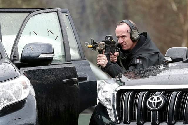 A member of the Close Protection Unit Royal Military Police carries out a demonstration during the NATO Military Police Close Protection conference at Longmoor Training Camp in Hampshire. PHOTO:  Andrew Mathews/PA Wire