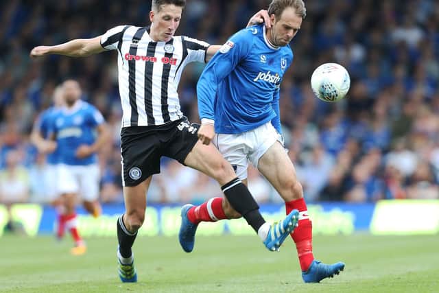 Ian Henderson battles Brett Pitman for the ball during Pompey's 2-0 win over Rochdale earlier this season. Picture: Joe Pepler/ PinPep