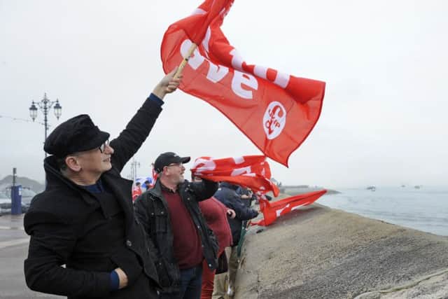 Supporters cheer on fishermen staging a waterborne protest against the EU outside Portsmouth Harbour